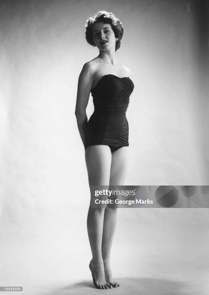 Woman in black corset posing in studio (B&W)