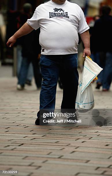 An overweight person walks through Glasgow City centre on October 10 Glasgow, Scotland. According to government health maps published today, people...