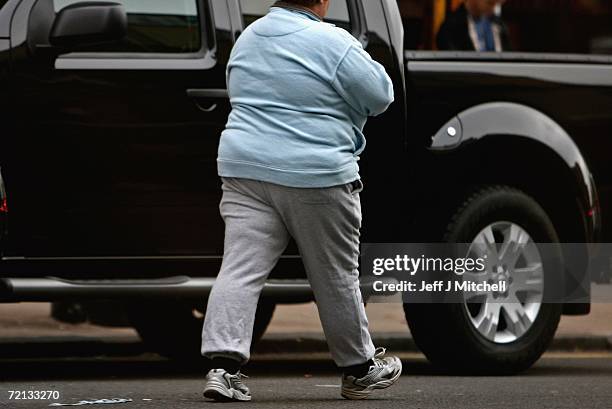 An overweight person walks through Glasgow city centre on October 10, 2006 in Glasgow, Scotland. According to government health maps published today,...