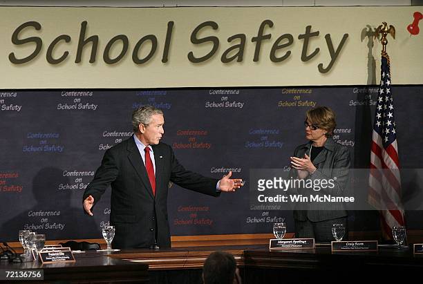 President George W. Bush is applauded by U.S. Education Secretary Margaret Spellings as he arrives to take part in a "Conference on School Safety"...