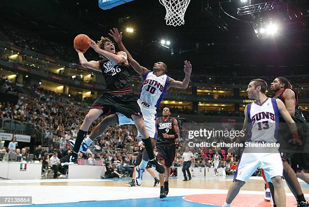 Kyle Korver of the Philadelphia 76ers at the basket against Leandro Barbosa of the Phoenix Suns during a preseason game as part of the NBA Europe...