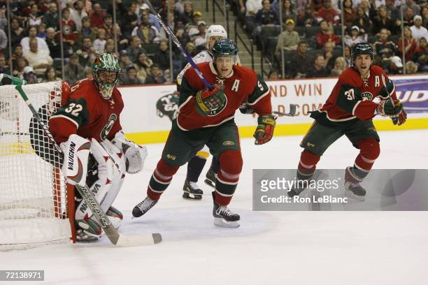Niklas Backstrom, Kim Johnsson, Wes Walz of the Minnesota Wild follow the action during a game against the Nashville Predators at Xcel Energy Center...