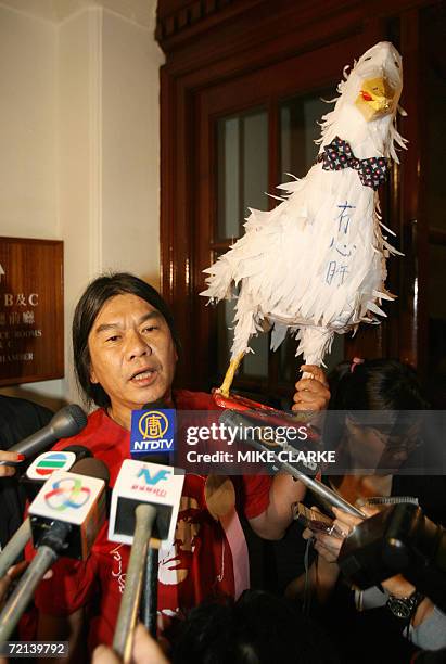 Pro deomcrcy legislator Leung Kwok Hung holds a model duck in a protest against Hong Kong Chief Executive Donald Tsang in the Legislative Council in...