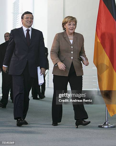 German Chancellor Angela Merkel and Jose Manuel Durao Barroso , chairman of the European Commission, arrive for a news conference at the chancellery...