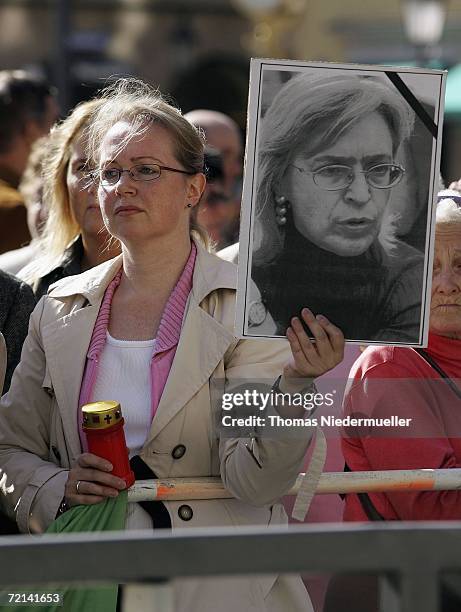 Demonstrater holds a portrait of murdered journalist Anna Politkowskaja the during arrival of Russian President Vladimir Putin and Bavarian Prime...