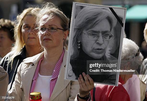 Demonstrater holds a portrait of murdered journalist Anna Politkowskaja the during arrival of Russian President Vladimir Putin and Bavarian Prime...