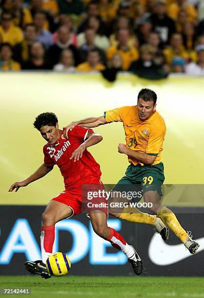 Bahrain's Faouzi Aaish attempts to clear the ball away from Australia's Mile Sterjovski during the Asian Cup Qualifier in Sydney, 11 October 2006....