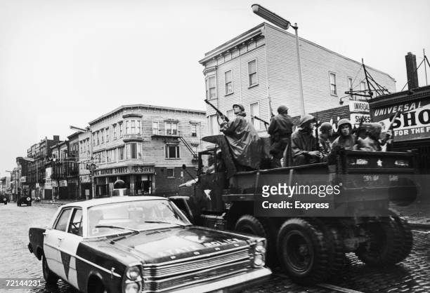 Members of the National Guard join the local police in searching for rooftop snipers during race rioting in Newark, New Jersey, 1967.