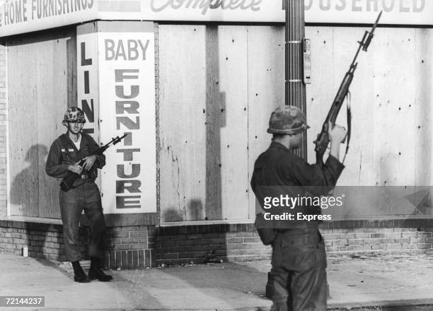 State troopers with bayonets stand outside a baby furniture store during rioting in the Watts area of Los Angeles, August 1965.
