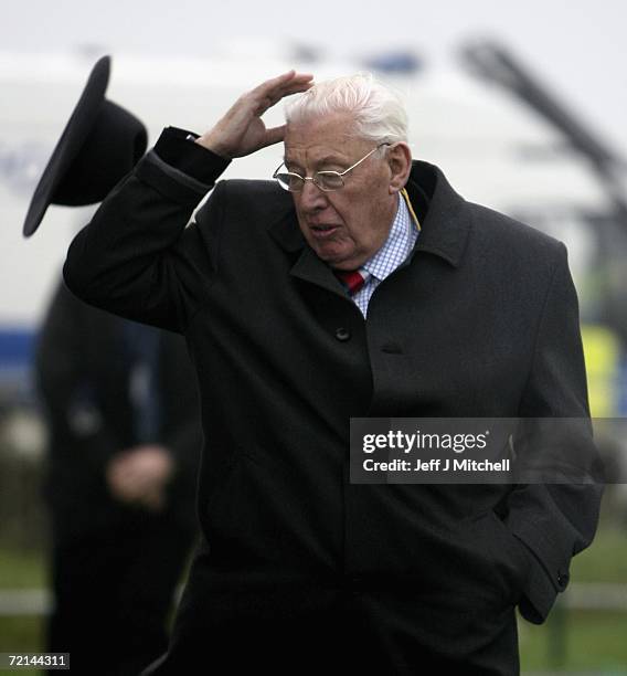 Ian Paisley, leader of the Democratic Unionist Party, has his hat blown off as he arrives at St Andrews for multi ? party negotiations to attempt to...