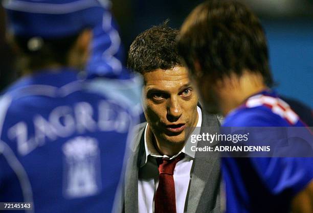 Manager of Croatia Slaven Bilic instructs one of his players as they leave the field at halftime during the Group E European Championships qualifying...