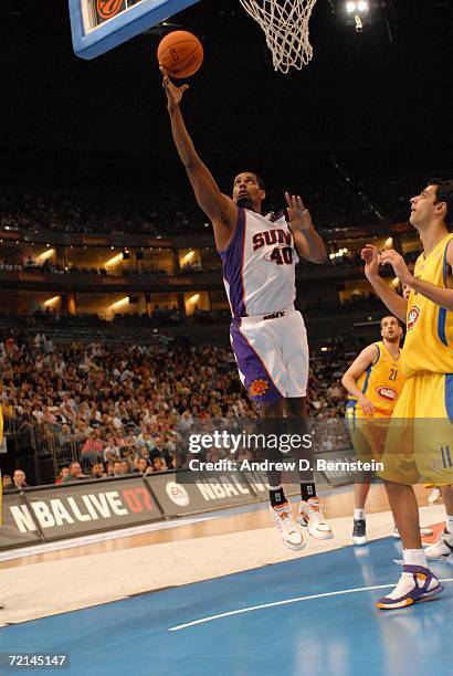 Kurt Thomas of the Phoenix Suns drives to the basket past Sharon Shason of Maccabi Elite Tel Aviv during a preseason game as part of the NBA Europe...