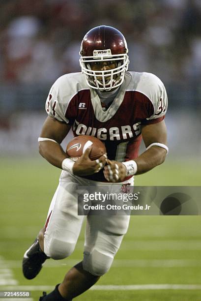 Running back Dwight Tardy of the Washington State Cougars carries the ball against the USC Trojans on September 30, 2006 at Martin Stadium in...