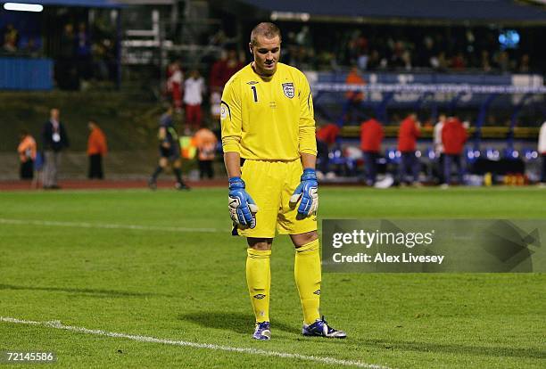 Paul Robinson of England looks in despair at a divot in the pitch after miss kicking a back pass to let the ball roll in for the second goal during...
