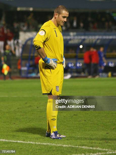 England's goalkeeper Paul Robinson looks at the ground after missing a kick which then rolled into the goal for Croatia's second goal during the...