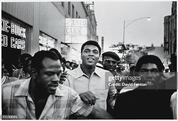 American heavyweight boxing champion Muhammad Ali walks through the streets with members of the Black Panther Party, New York, New York, September...
