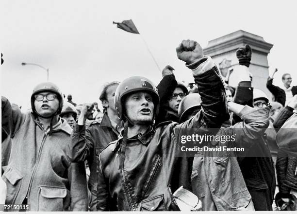 Young men raise their fists and chant slogans during the 'Days of Rage' demonstrations organized by the Weathermen to protest the Chicago Seven trial...