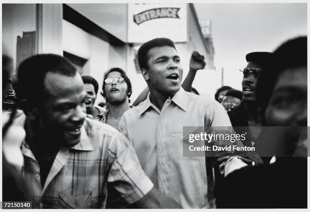 American heavyweight boxing champion Muhammad Ali walks through the streets with members of the Black Panther Party, New York, New York, September...