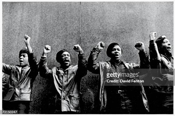 View of a line of Black Panther Party members as they demonstrate, fists, outside the New York County Criminal Court , New York, New York, April 11,...