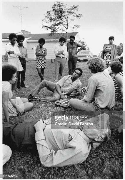 Black Panther Party co-founder Huey P. Newton reclines on the grass as he answers questions from a Liberation News Service reporter on the campus of...