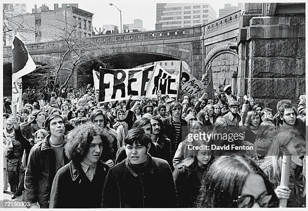 Demontrators march with a 'Free Huey' banner in support of the Black Panther Party, New York, New York, April 4, 1970. The banner refers to...
