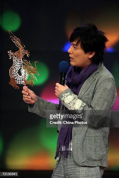 Taiwan singer Jeff Chang holds an eatable sugar dragon made by a folk artist during a fan club activity to promote his new album on October 11, 2006...