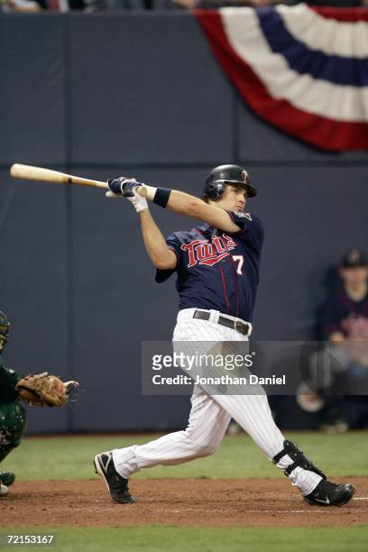 Joe Mauer of the Minnesota Twins swings at the pitch against the Oakland Athletics during game two of the American League Division Series at the...