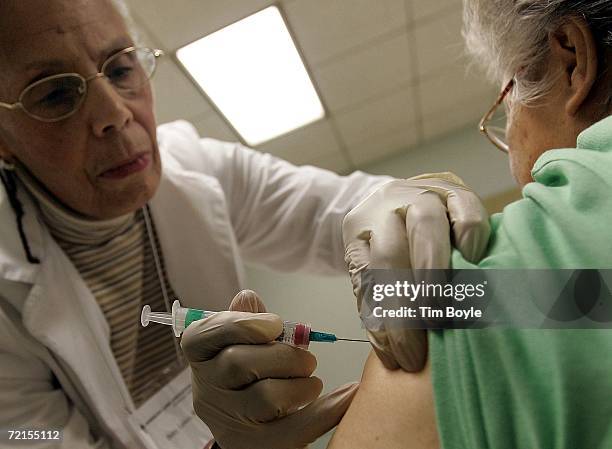 Elaine Louie receives a flu shot, offered free by the city of Chicago from registered nurse Betty Lewis October 12, 2006 in Chicago, Illinois. In a...