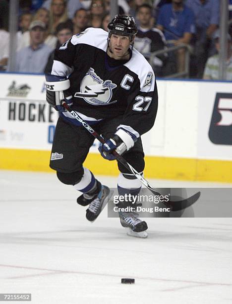 Tim Taylor of the Tampa Bay Lightning skates for the puck during the game against the Boston Bruins at the St. Pete Times Forum on October 7, 2006 in...