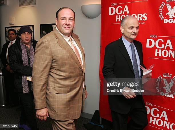 Honoree David Chase walks holding his award with presenters Steve Van Zandt and James Gandolfini in the press room at the 2006 DGA Honors at the...