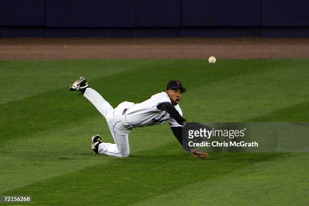 Endy Chavez of the New York Mets dives to catch a ball hit by Ronnie Belliard of the St. Louis Cardinals during game one of the NLCS at Shea Stadium...