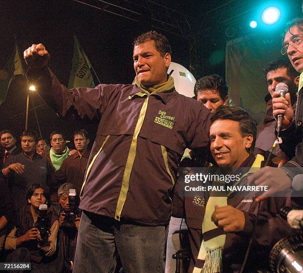 Presidential candidate Rafael Correa , of the Country Alliance party, cheers at supporters next to his Vice-President candidate Lenin Moreno during...