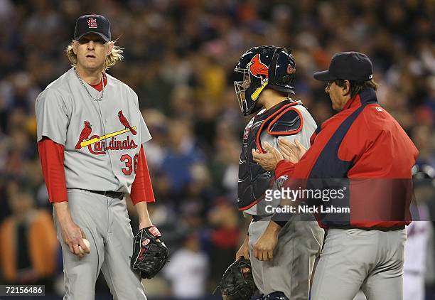 Manager Tony LaRussa comes to the mound to taks the ball from starting pitcher Jeff Weaver while catcher Yadier Molina of the St. Louis...