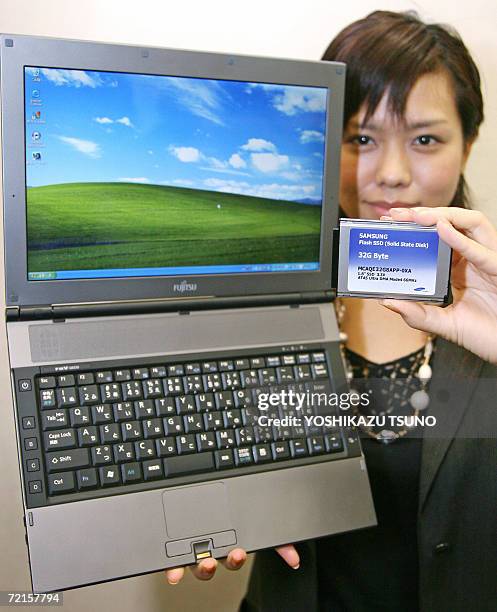 Japan's computer giant Fujitsu employee Miho Hirasawa displays the company's new notebook PC "FMV-Lifebook FMV-Q8230", equipped with Intel's 1.2 GHz...