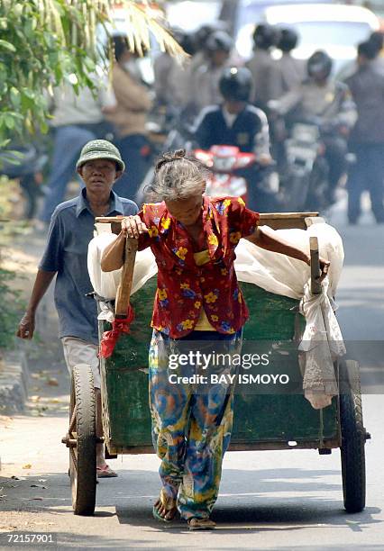 Women scrap collectors pull their cart in Jakarta 12 October 2006. The consumer confidence index in September reached 96.1, its highest mark in the...