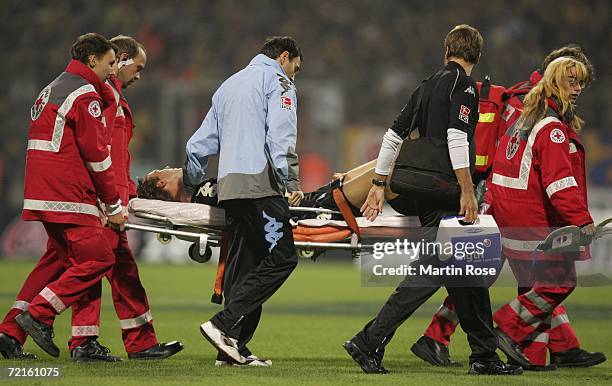 Michael Hofmann goalkeeper of 1860 Munich is carried off injured after a collision with Tobias Schweinsteiger of Braunschweig during the Second...