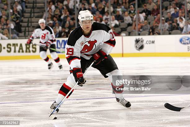 Travis Zajac of the New Jersey Devils skates with the puck during a game against the Dallas Stars at American Airlines Center on October 7, 2006 in...