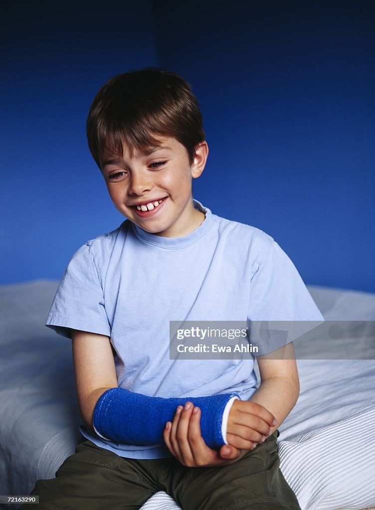 Boy with his arm in a plaster.