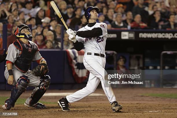 Shawn Green of the New York Mets watches the flight of the ball as he follows through on his swing during game one of the NLCS against the St. Louis...