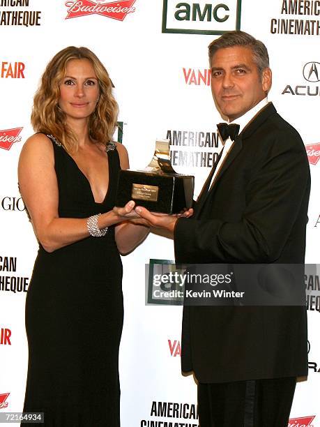 Actress Julia Roberts and actor/Director George Clooney pose in the press room at the 21st Annual American Cinematheque Award Honoring George Clooney...