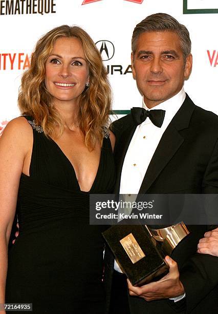 Actress Julia Roberts and actor/Director George Clooney pose in the press room at the 21st Annual American Cinematheque Award Honoring George Clooney...