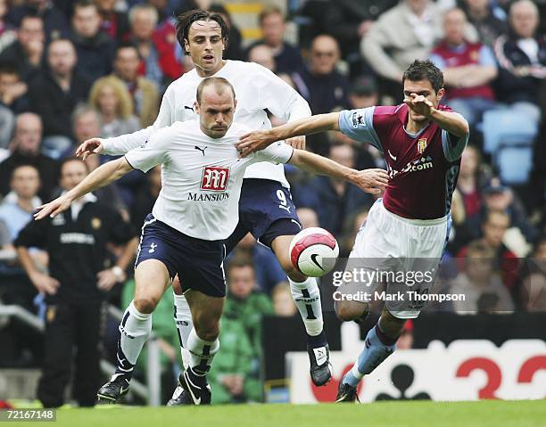 Danny Murphy and Dimitar Berbatov of Tottenham tangle with Aaron Hughes of Aston Villa during the Barclays premiership match between Aston Villa and...