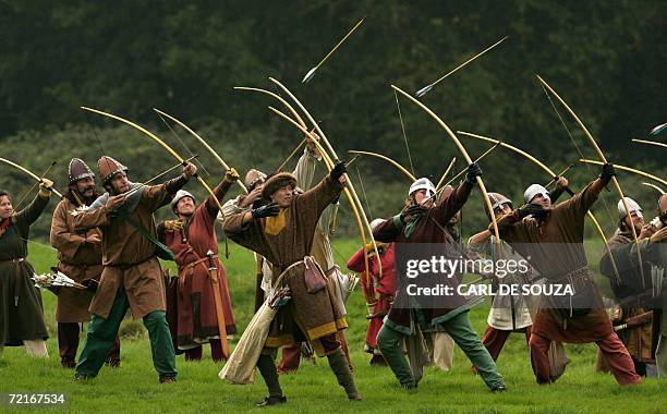 Hastings, UNITED KINGDOM: Participants dressed as Norman archers take part in an event to re-enact the 1066 Battle of Hastings at Battle Abbey, East...