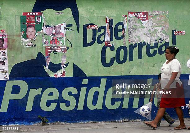 Woman passes by electoral propaganda of presidential candidate Rafael Correa 14 October in the town of Recreo, Guayas province, Ecuador. Leftist US...
