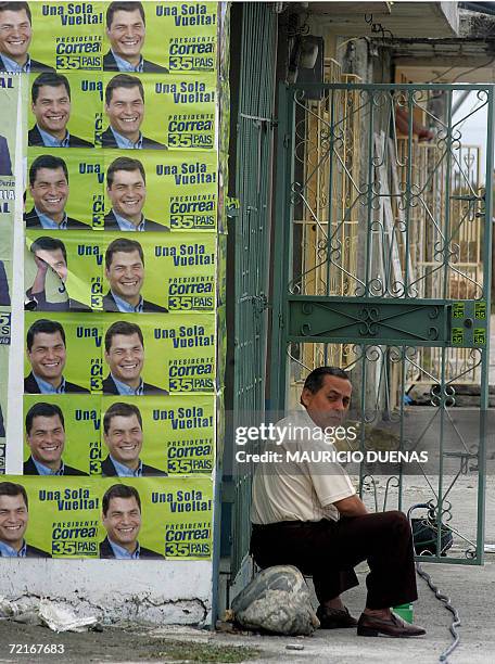 Man sits next to propaganda of presidential candidate Rafael Correa 14 October in the town of Recreo, Guayas province, Ecuador. Leftist US critic...