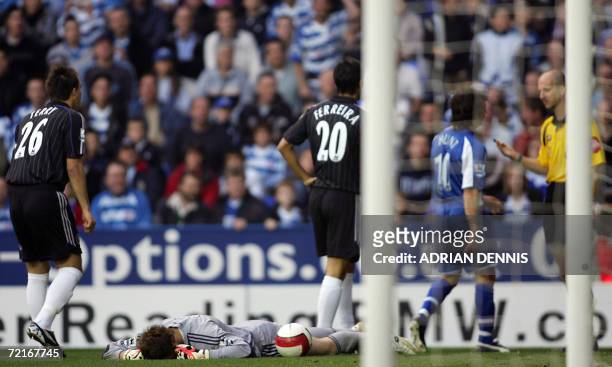 Reading, UNITED KINGDOM: Chelsea's goalkeeper Petr Cech lies injured in the first few minutes of the game after a tackle from Stephen Hunt of Reading...