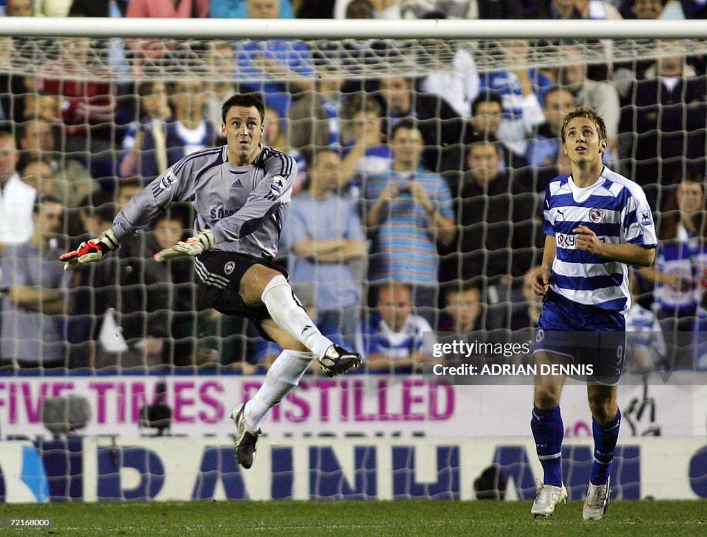 Chelsea's John Terry (L) clears the ball