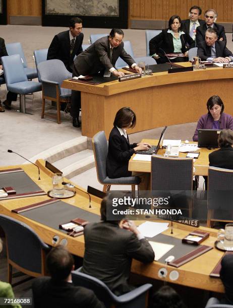 Pak Gil Yon , North Korea's Ambassador to the United Nations, adjusts the nameplate on his seat at the Security Council, 14 October 2006, just before...