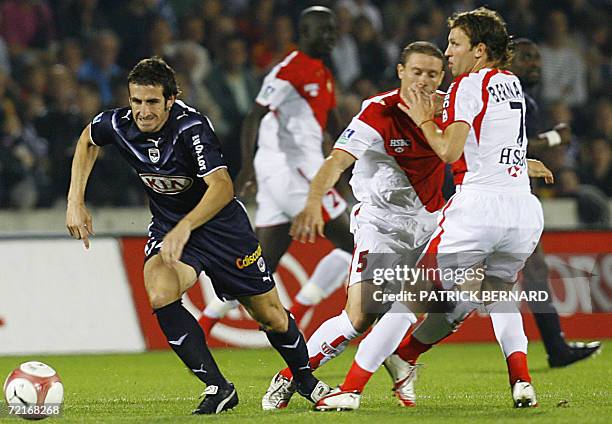 Bordeaux' midfielder Johan Micoud vies with Monaco's midfielder Lucas Bernardi and Diego Perez during their French L1 football match, 14 October 2006...