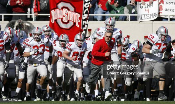 Jim Tressel, head coach of the Ohio State Buckeyes, leads his team onto the field for a game against the Michigan State Spartans on October 14, 2006...